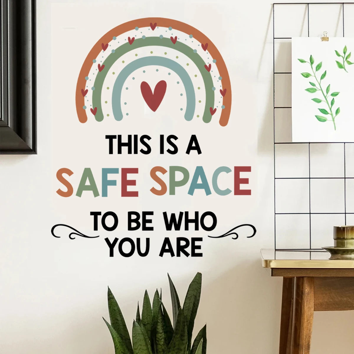 Decorative wall sticker with rainbow and text 'This is a safe space to be who you are' on a wall.