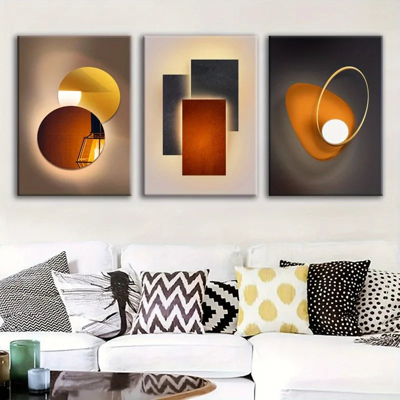 Three abstract wall art pieces above a white sofa with decorative pillows.