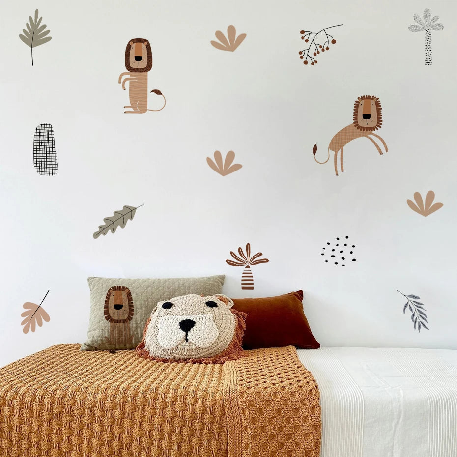 Children's room with lion-themed wall decals and decorative pillows on a bed.