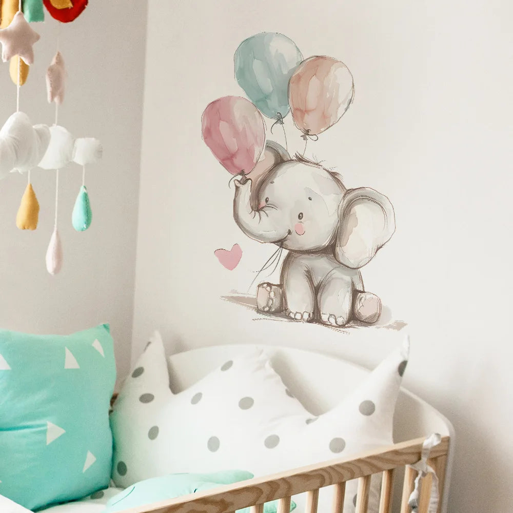 Children's room with a crib, colorful pillows, and an elephant wall decal holding balloons.