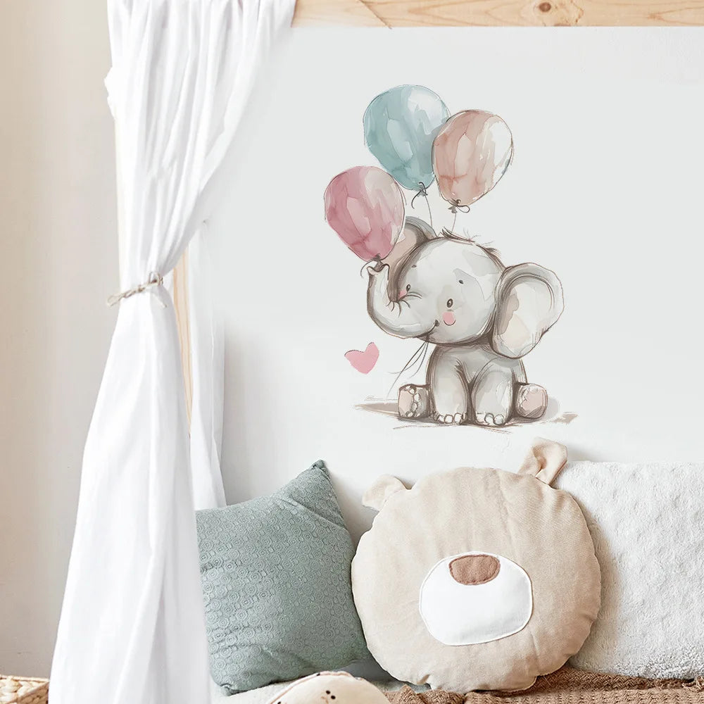 Wall decal of an elephant with balloons on a wall above two cushions.