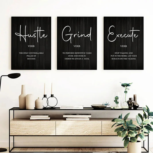 Three motivational posters on a wall above a console table with decor items.