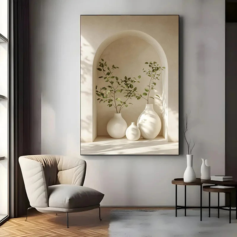 Decorative wall art of white vases and green plants in a neutral-toned frame, displayed in a modern living room.