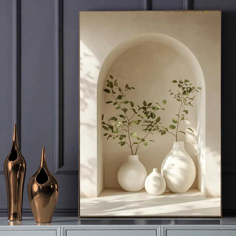 Decorative scene with white vases and a plant against a neutral wall.