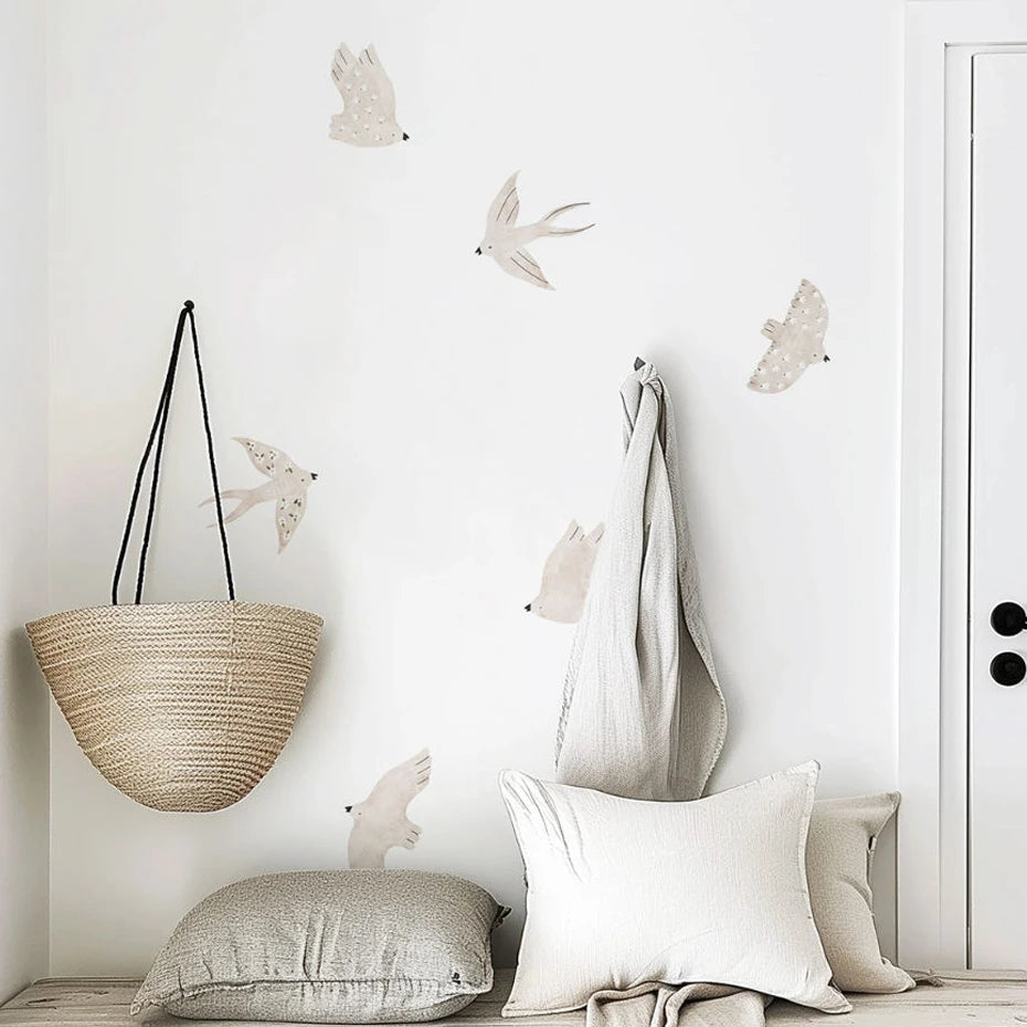 Decorative wall with hanging basket, pillows, and wall art on a white wall.