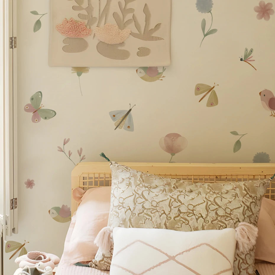 Decorative headboard with pillows against a wall featuring floral and butterfly wallpaper.