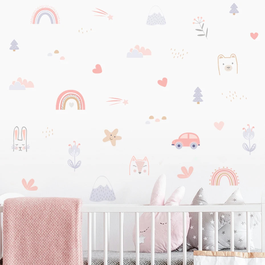 Nursery room with crib and decorative wall stickers featuring animals, cars, and abstract shapes.