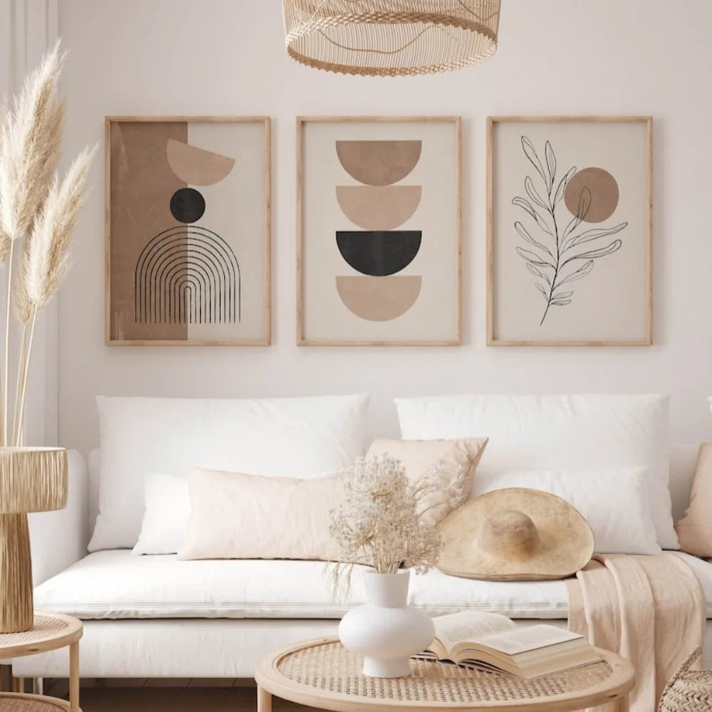 Living room with a white sofa, decorative pillows, and framed abstract art on the wall.