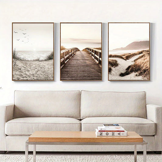 Three framed beach scenes above a beige sofa with a wooden coffee table.