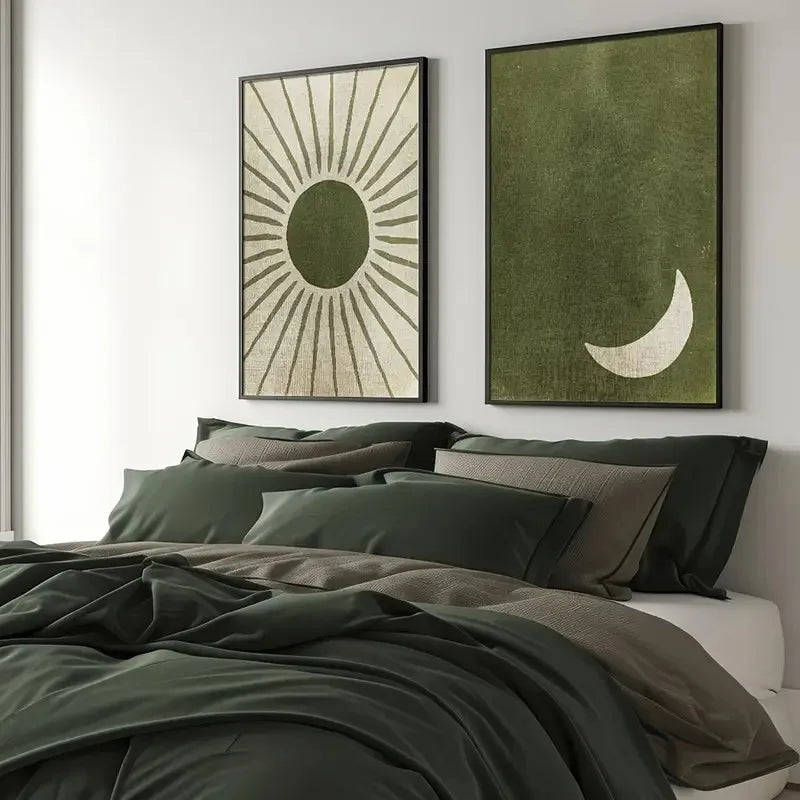 Bedroom with green bedding and wall art featuring a sun and moon design.