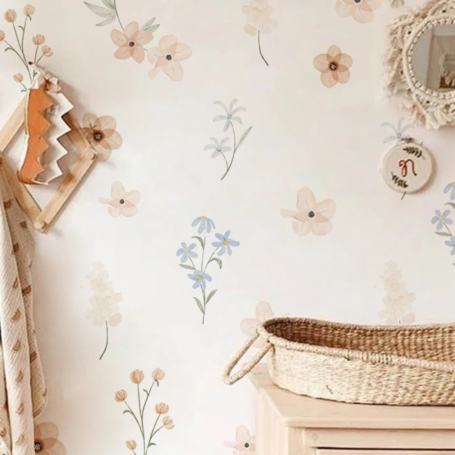 Nursery room with floral decals, wooden decor, and a basket on a light-colored wall.