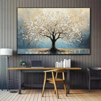 Decorative painting of a tree on a wall above a desk with books and a laptop.