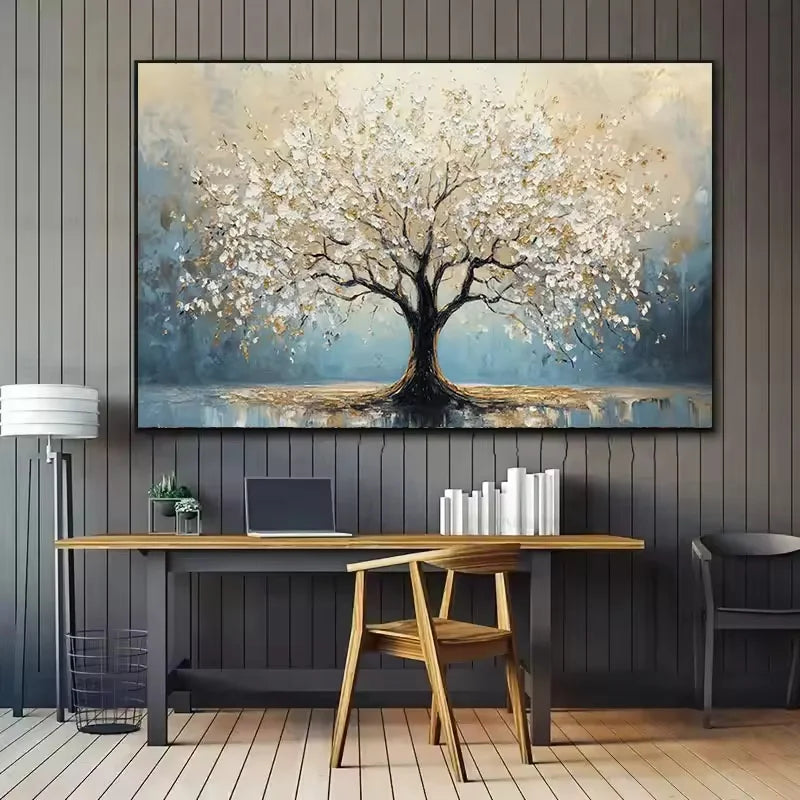 Decorative painting of a tree on a wall above a desk with books and a laptop.