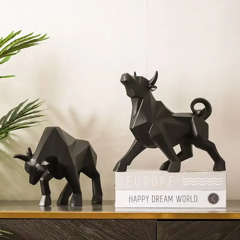 Two black bull statues on a shelf with a decorative box labeled 'Europe Happy Dream World'.