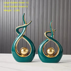 Two decorative vases with gold accents on a plain background