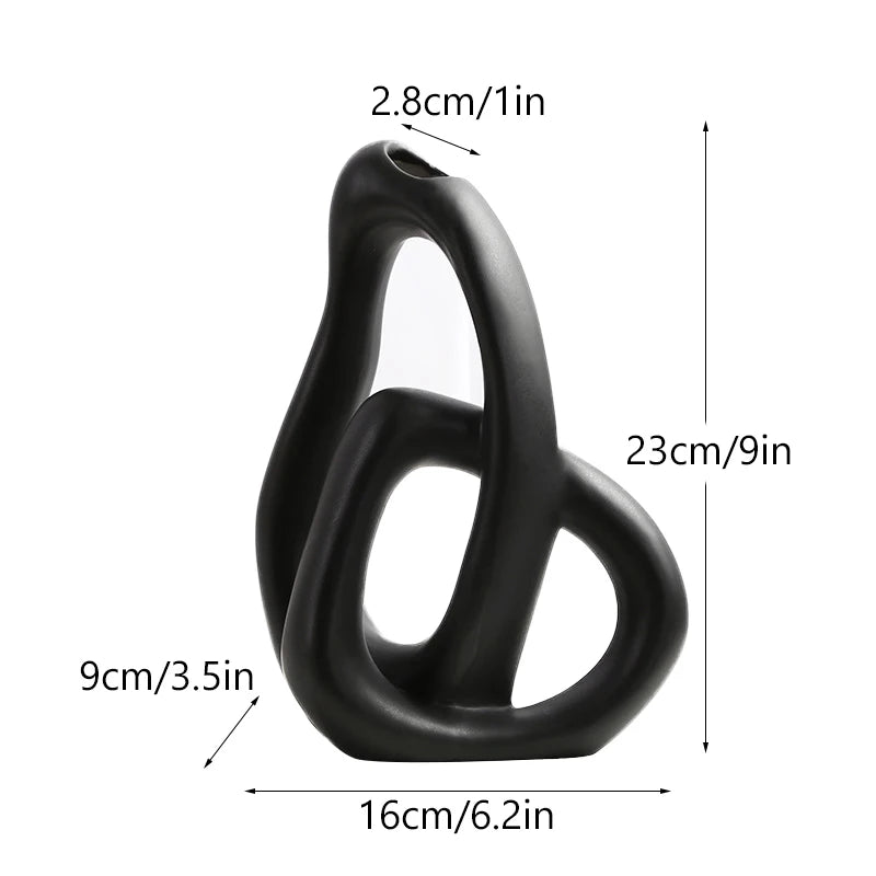 Black ceramic sculpture with measurements on a white background