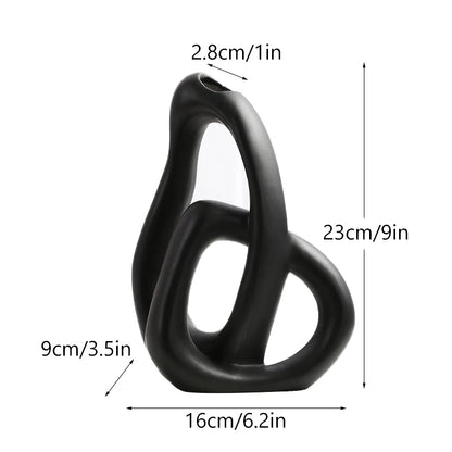 Black ceramic sculpture with measurements on a white background
