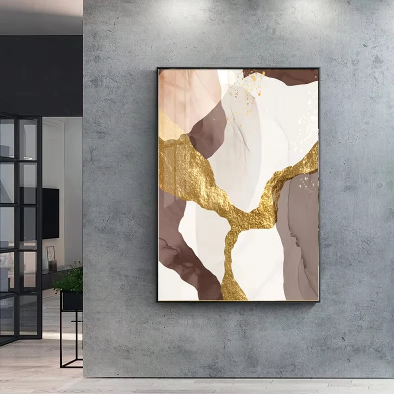 Abstract art piece with gold and brown elements on a gray wall.