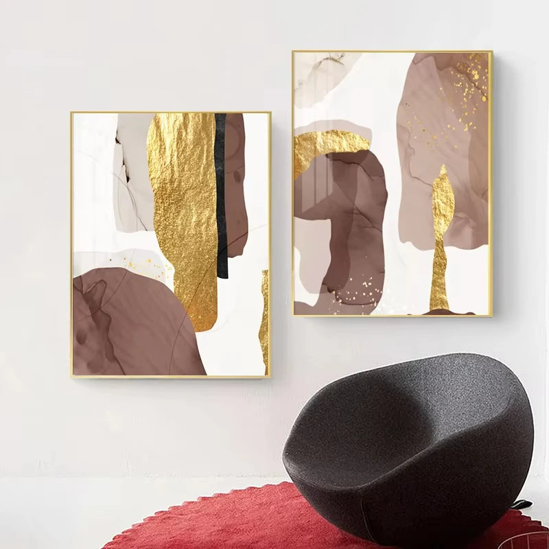 Two abstract art pieces with gold accents on a wall above a black chair and red cushion.