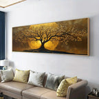 A large rectangular wall art piece showing a stylized tree with golden foliage and branches against a glowing gold and brown background, displayed above a beige sofa in a modern living room.