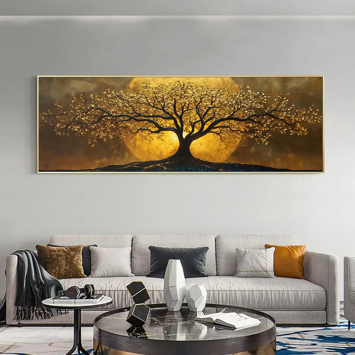 A large horizontal canvas painting of a tree with golden leaves and glowing sun-like circles in the background, displayed above a modern light gray sofa in a styled living room.