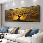 A large wall art piece showing a stylized tree with golden leaves and branches against a glowing yellow circular background, displayed above a white sofa with blue and beige pillows in a modern living room.