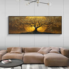 A large horizontal wall art piece showing a stylized tree with glowing golden foliage against a warm brown and gold background, displayed above a beige sectional sofa in a modern living room.