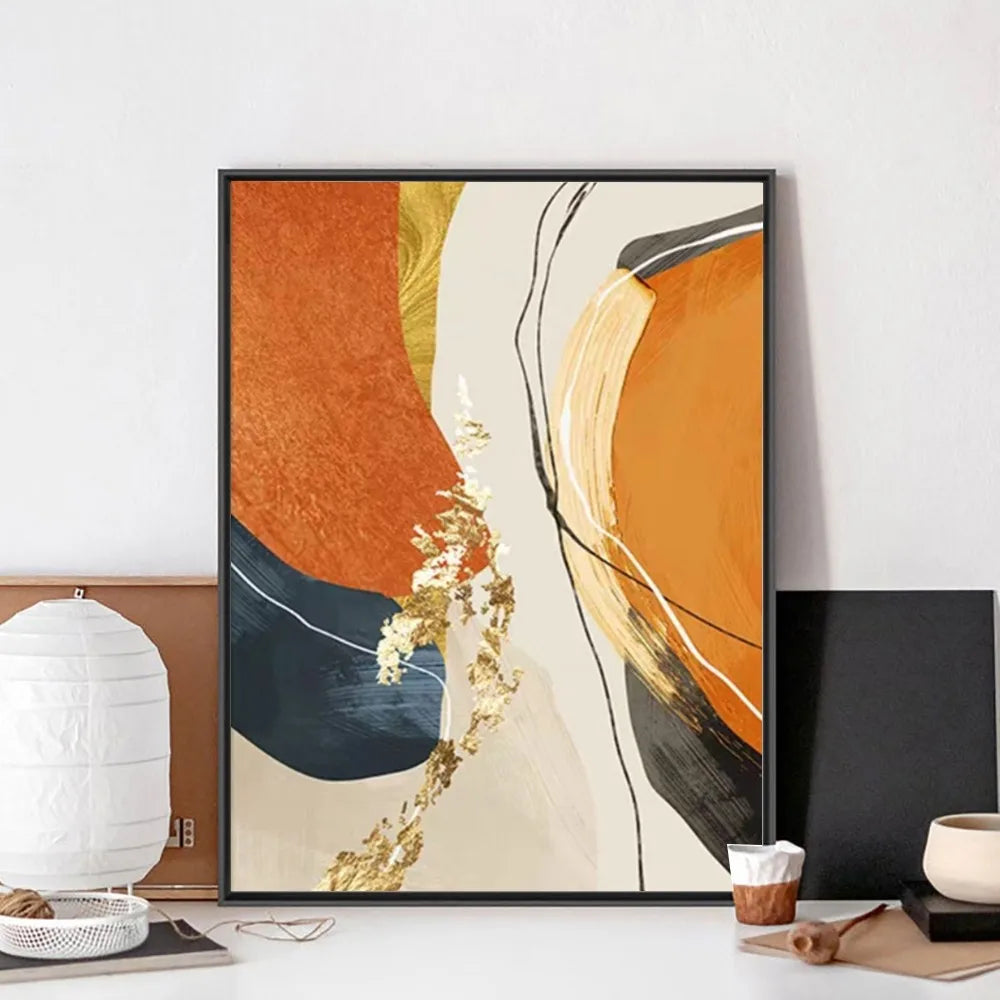 Abstract art print with orange, blue, and gold colors on a white wall.