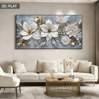 A large rectangular wall art piece showing oversized white flowers with gold and silver leaves on a gray-blue background, displayed above a cream sofa in a modern living room. 