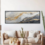 Framed abstract art piece on a wall above a beige sofa with decorative elements.