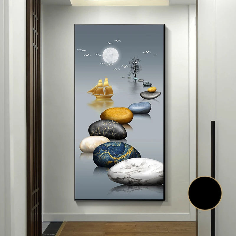 Decorative wall art with stones, sailboat, and moon on a gray background, displayed in a room.