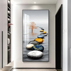 Decorative wall art of colored stones and a tree in a modern interior setting.