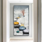 Decorative wall art of stones and a tree in a modern interior setting