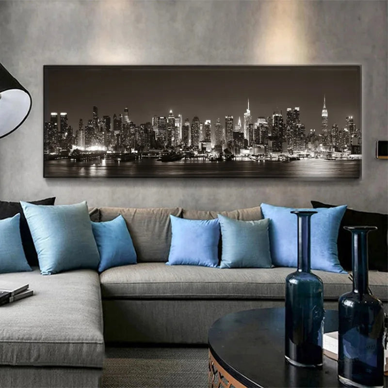 Living room with a large cityscape painting on the wall, gray sofa with blue pillows, and dark coffee table.