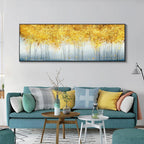 Living room with teal sofa, yellow cushions, and a large abstract painting of golden trees.
