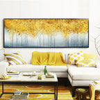 Living room with a large abstract painting of golden trees, white sofa, and decorative items.