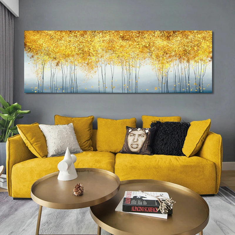 Yellow sofa with decorative pillows in a living room with a large abstract painting on the wall.