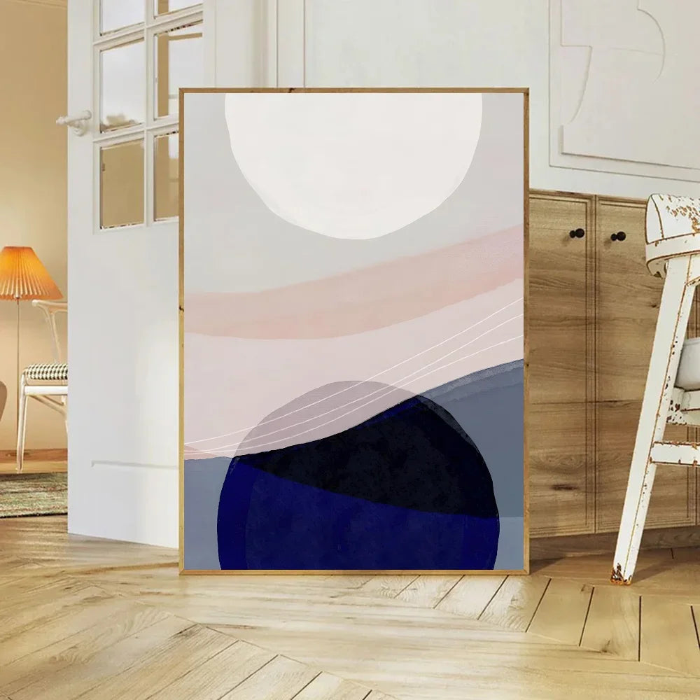 Abstract art print in a gold frame on a wooden floor