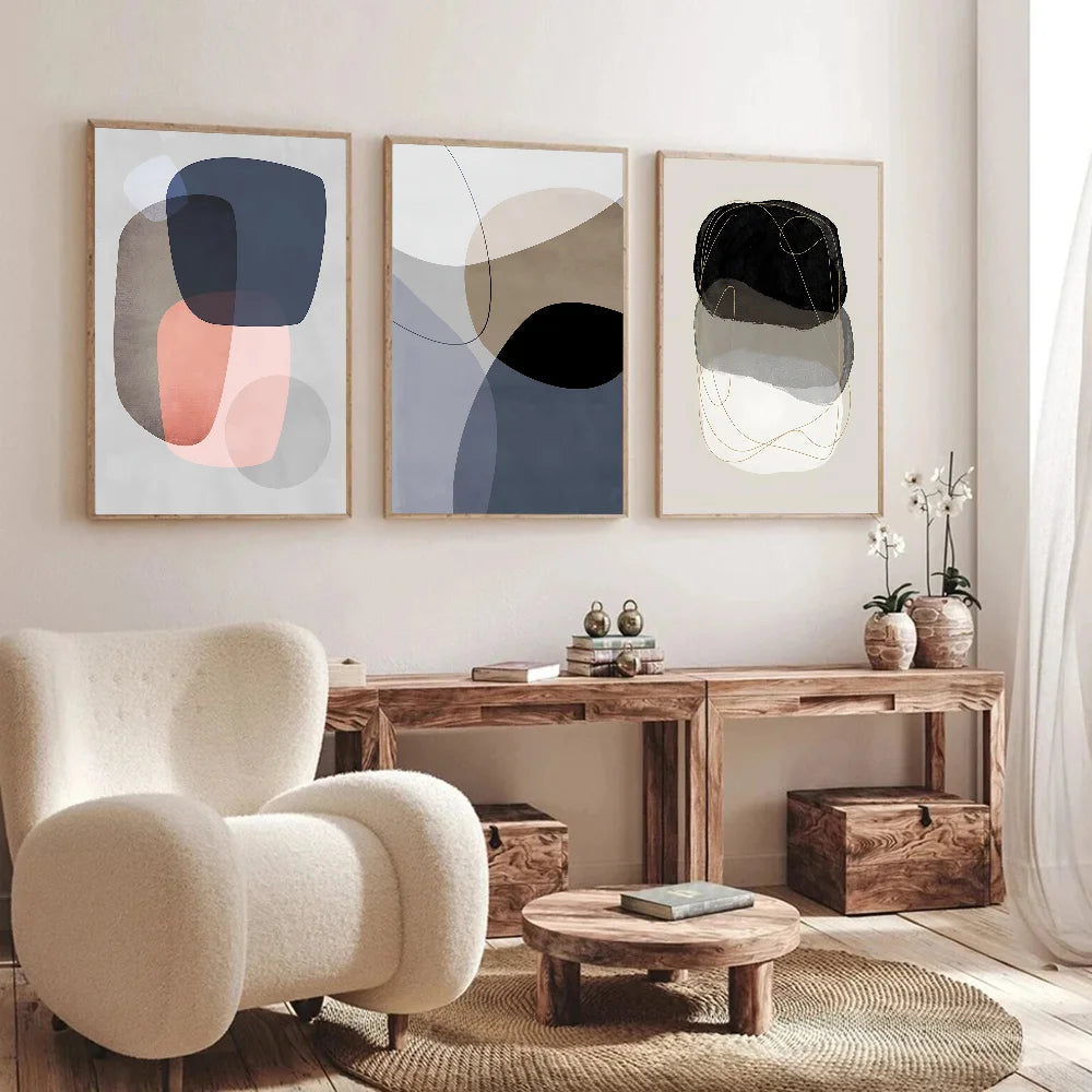 Modern living room with abstract art, a beige armchair, and wooden furniture.