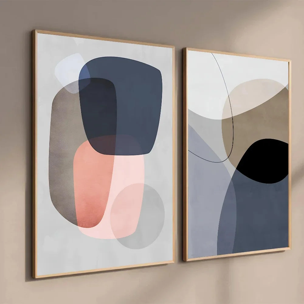 Two abstract art pieces in frames on a beige wall