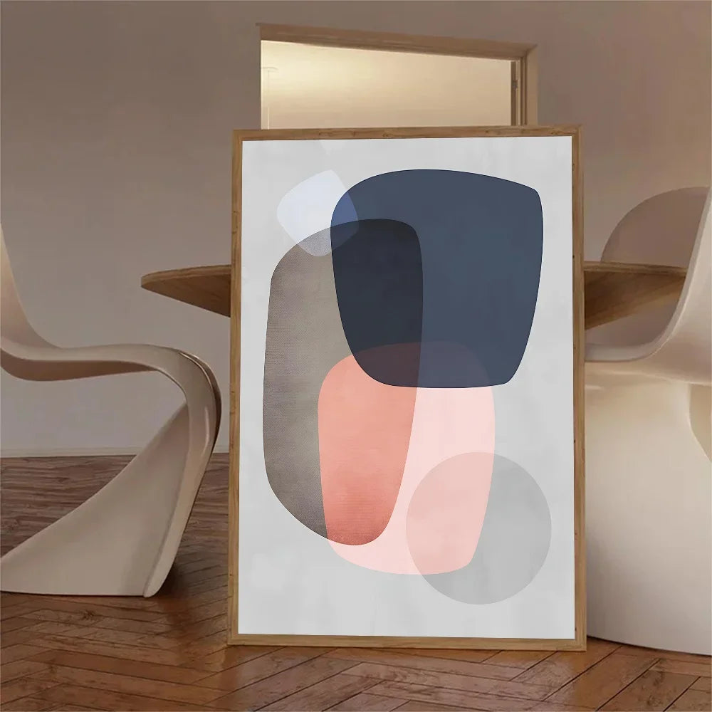 Framed abstract art piece on a wooden floor with modern chairs.