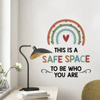 Wall decal with rainbow and heart design on a wall with a lamp and books in the foreground.