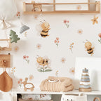 Nursery room with wooden toys, plush bee, and floral wallpaper.