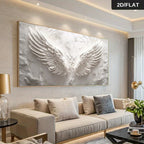 Living room with a large abstract painting of wings on the wall above a beige sofa.