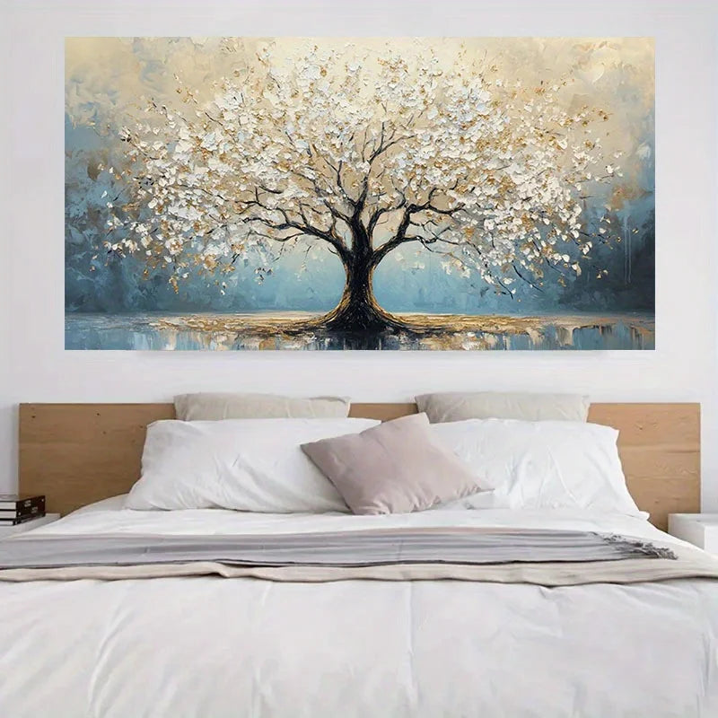 Decorative wall art of a tree with white flowers above a bed.