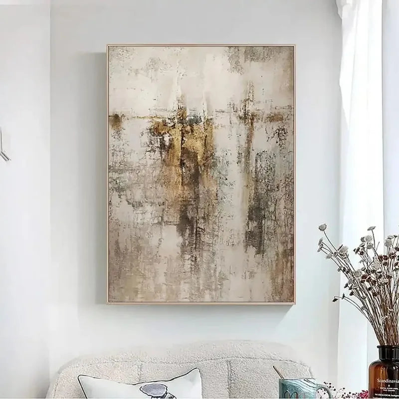 Abstract art painting on a wall above a sofa with decorative elements.