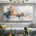 Modern living room with a large abstract painting above a gray sofa.