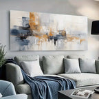 Modern living room with a gray sofa, abstract painting, and decorative items.
