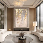 Modern living room with abstract wall art, white sofa, and round coffee table.