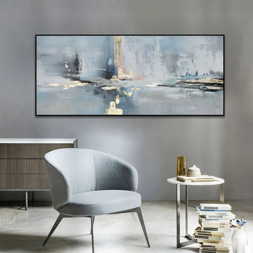 Modern interior with a gray armchair, side table, and abstract painting on a gray wall.